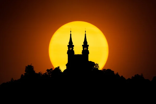 Church on the Pöstlingberg with the sun directly behind it