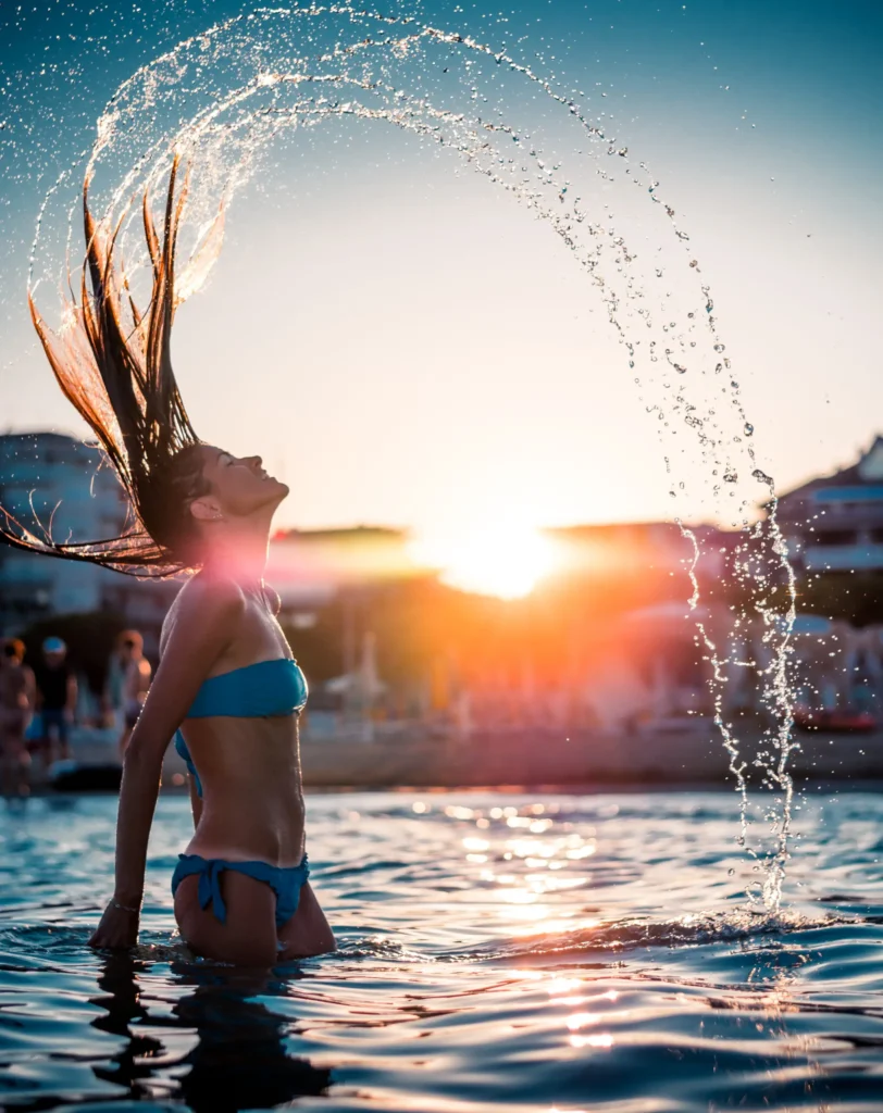 Eva in water creating a water fountain with her hair